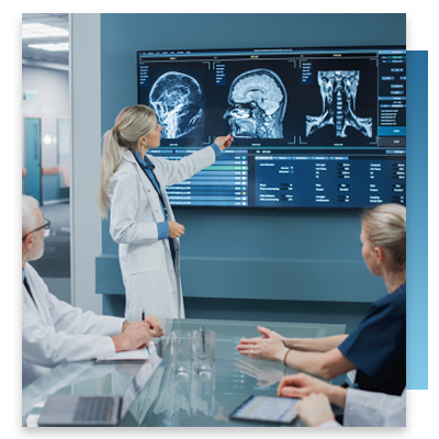 A doctor going over scans on a digital screen in a meeting room