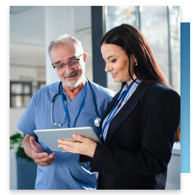A trainer showing a nurse new features on a tablet
