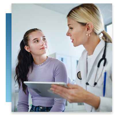 A young patient looking at a tablet with a doctor