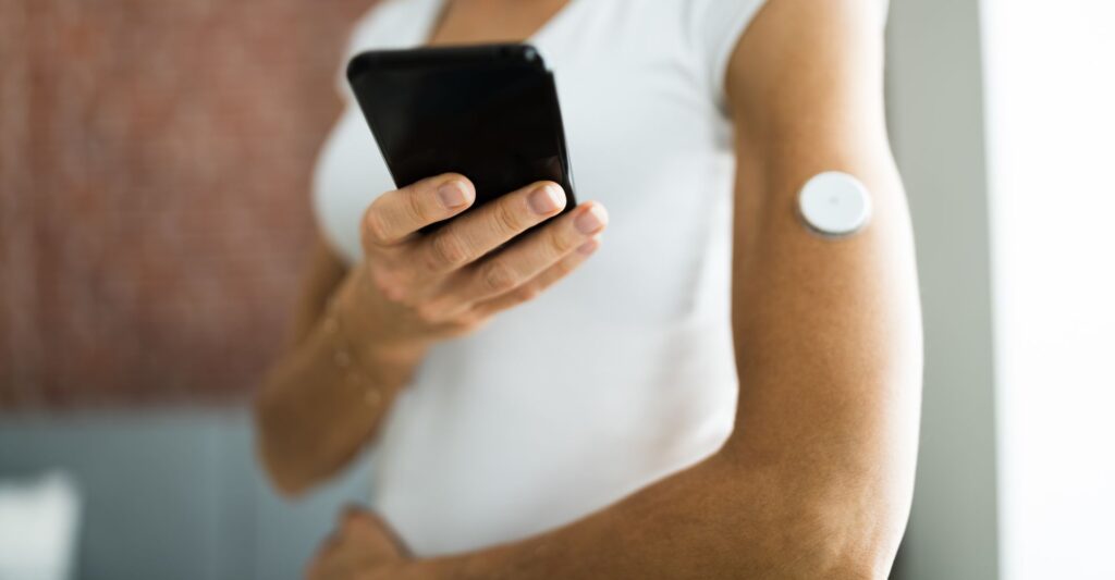 A woman checking her blood sugar with an app