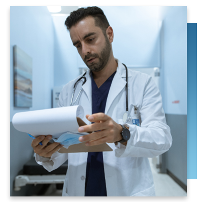 A doctor looking at a patient chart on a clipboard