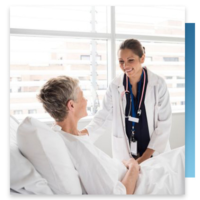 A doctor checking on a patient in their hospital room