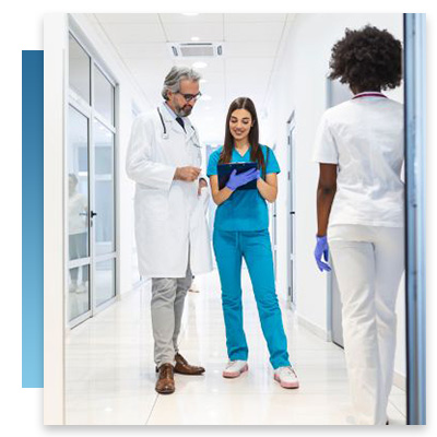 A nurse and doctor talking in a hall