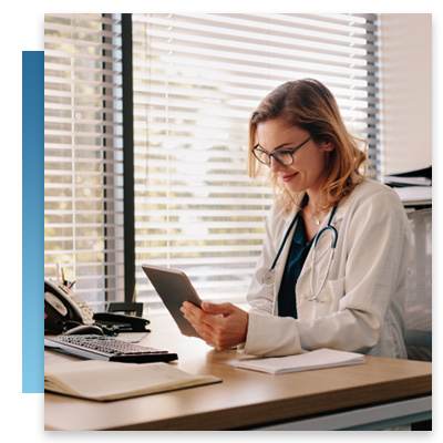 A doctor on her tablet at her desk