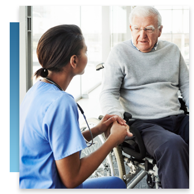 A nurse speaking with a patient in a wheelchair