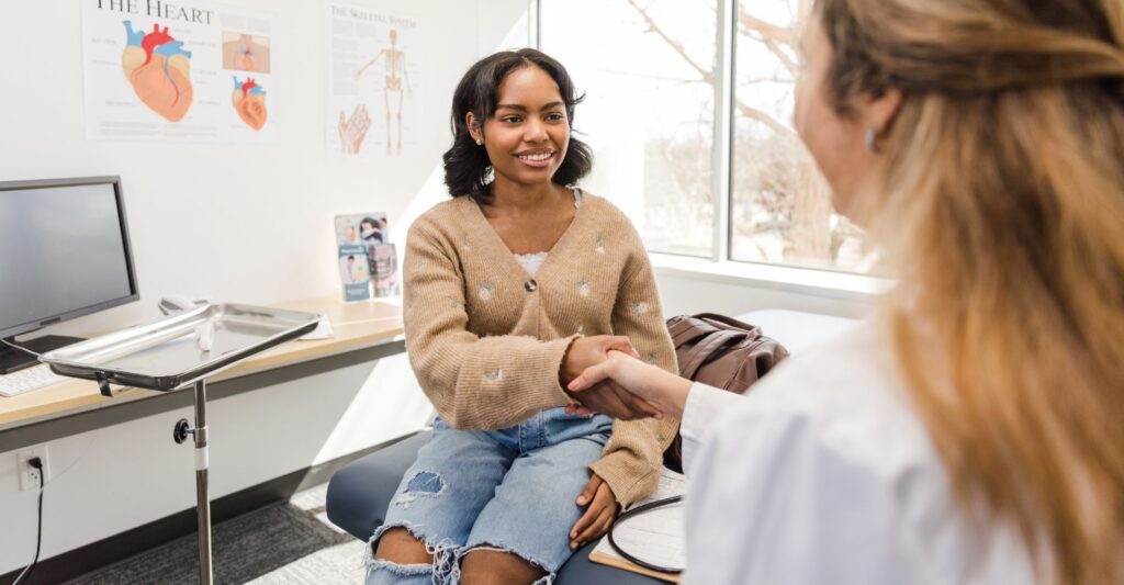 A doctor shaking hands with a patient