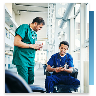 A doctor and a nurse looking at a smartphone