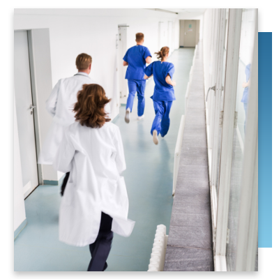 Doctors and nurses hurrying down a hallway