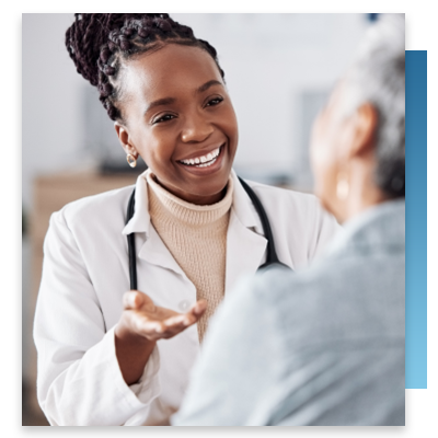 A doctor smiling while talking to a patient